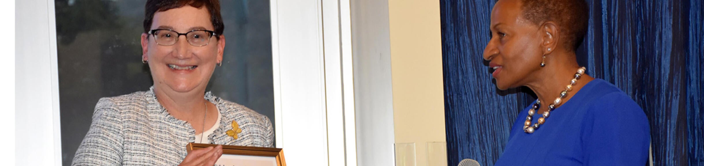 Deborah Deas presenting a gift to Carrie Byington