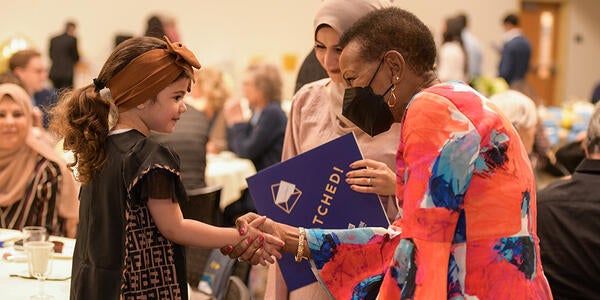 Dean Deas shaking hands with a young girl at Match Day 2022