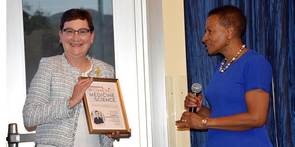 Deborah Deas presenting a gift to Carrie Byington