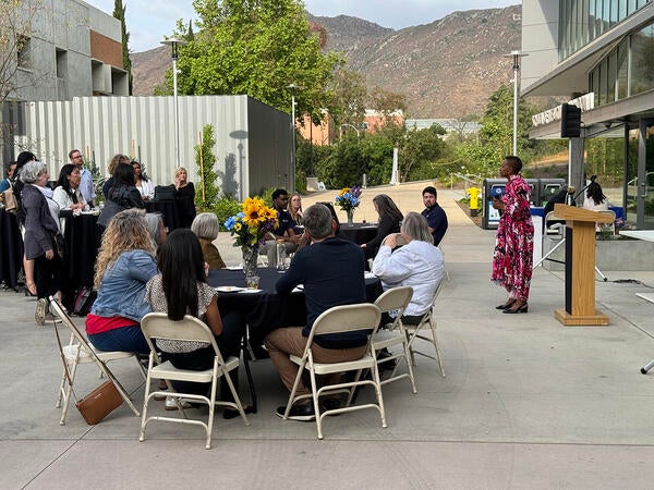 Dean Deas speaking at an event in the courtyard