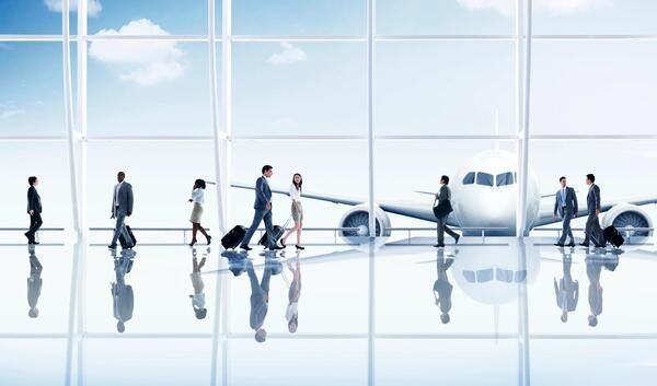 stylized photo of people walking through an airport concourse